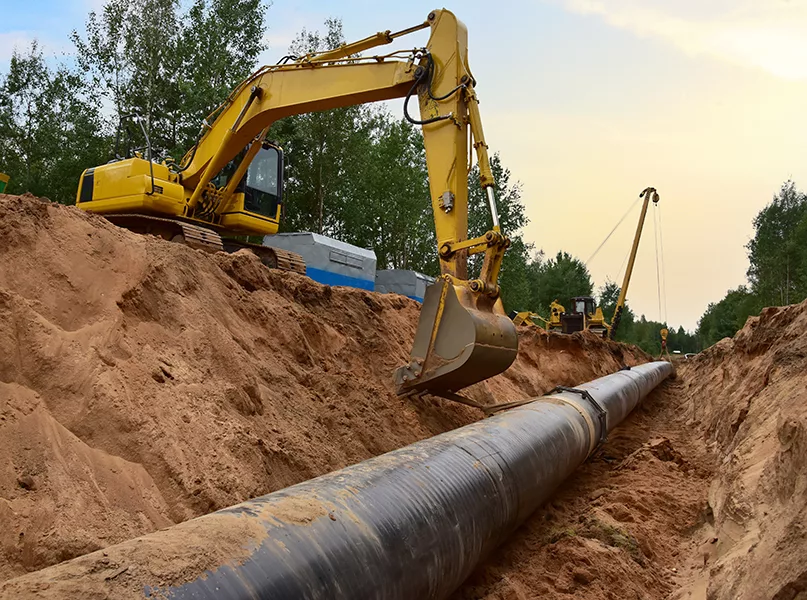 Natural Gas Pipeline Construction. Gas and Crude oil transmission in pipe from gas storage and plant development to facility.  Excavator and pipelayer during building of transit petrochemical pipes