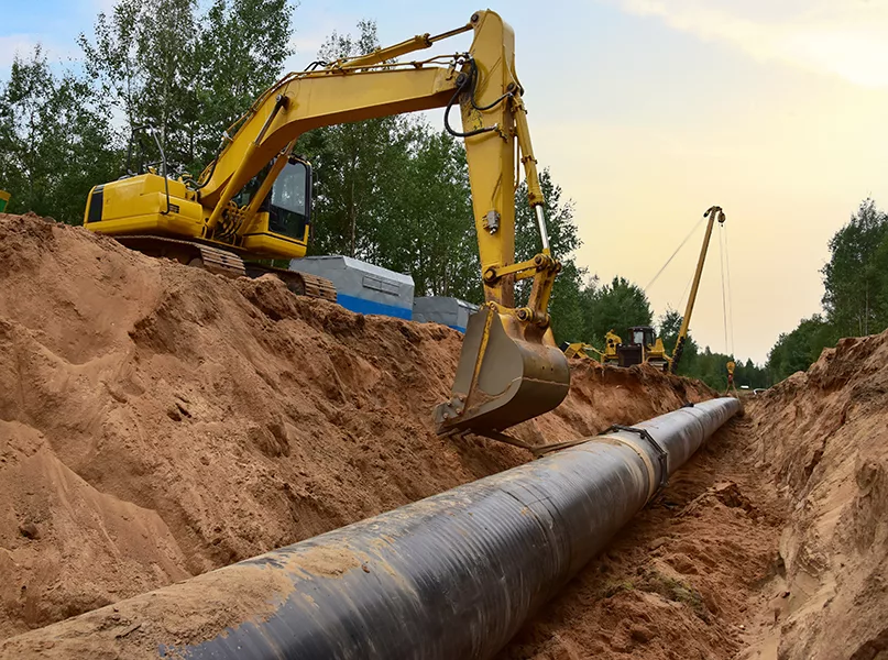 Natural Gas Pipeline Construction. Gas and Crude oil transmission in pipe from gas storage and plant development to facility. Excavator and pipelayer during building of transit petrochemical pipes