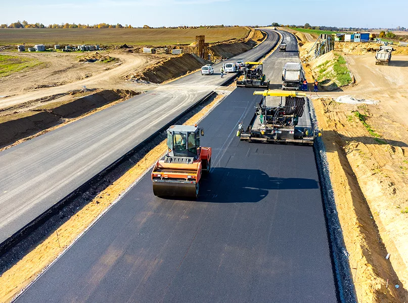 Aerial view on the road rollers building the new asphalt road