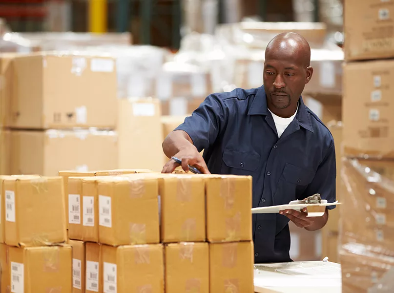 Worker In Warehouse Preparing Goods