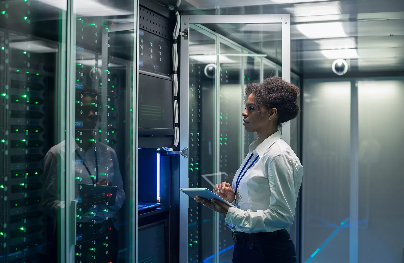 Technician works on a tablet in a data center