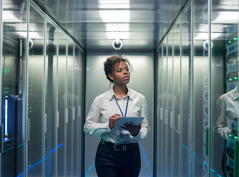 Woman with tablet diagnosing server hardware