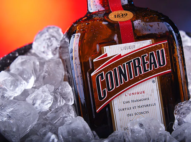 Bottle of Cointreau triple sec in bucket with crushed ice