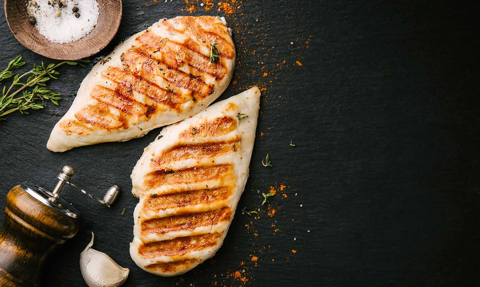 Grilled chicken breast served on black slate