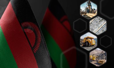 Small national flags of the Malawi on a dark background