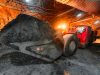 An underground loading machine carries a full bucket of ore. © istock/ukwazi